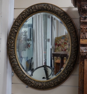 A gilt-framed oval mirror, width 66cm, height 78cm